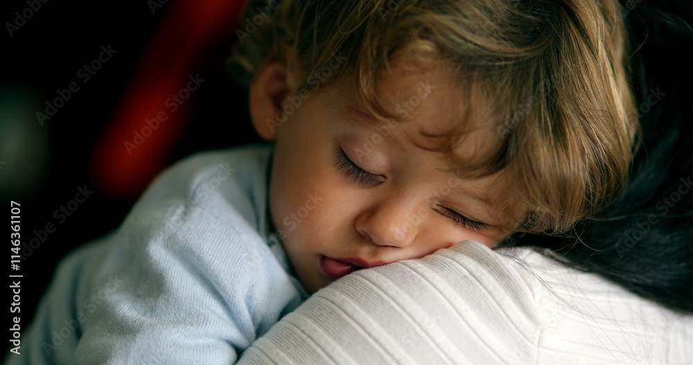 Toddler boy asleep on mother shoulder. Child sleeping. Baby napping Toddler boy asleep on mother shoulder. Child sleeping. Baby napping