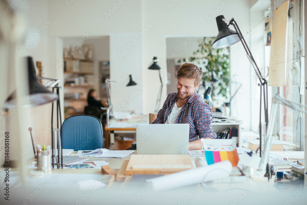 Young male architect working on a project in the office