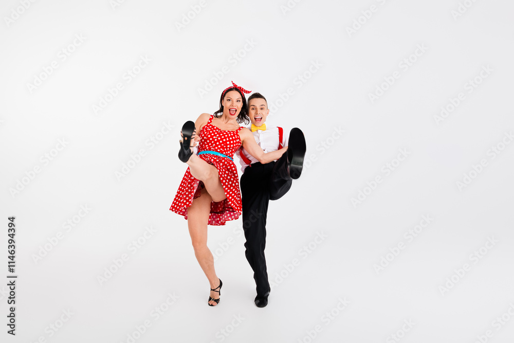 Full size photo of two elegant young people dancing raise leg shoe sole empty space isolated on white color background Full size photo of two elegant young people dancing raise leg shoe sole empty space isolated on white color background