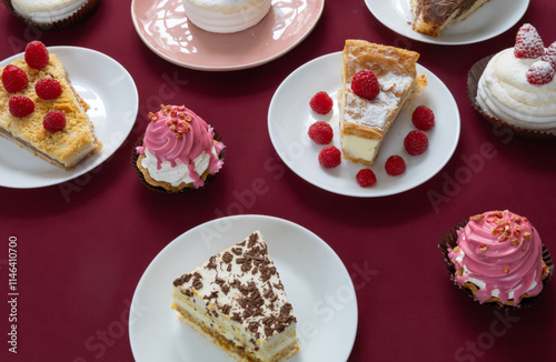 desserts with raspberries on white plates on the table
