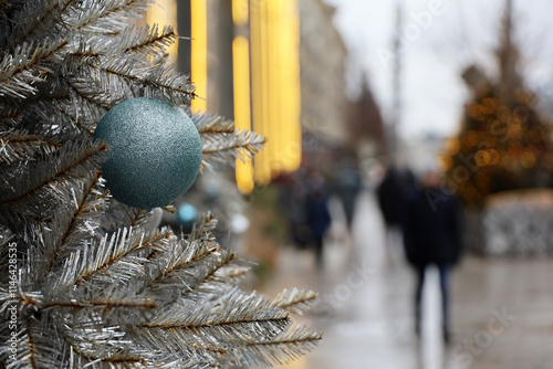 Canvas Print New Year celebration in city, Christmas tree with toy ball on a street on walkin