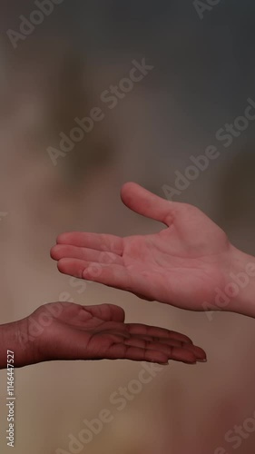 This artwork features an open hand gesture set against a vibrant abstract background