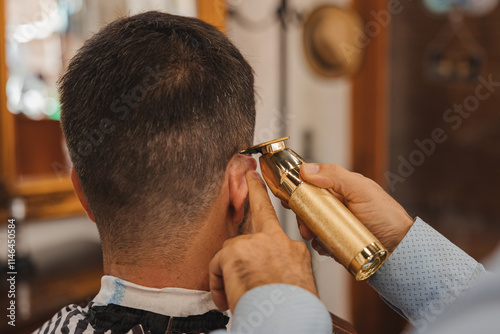 A man is getting his hair cut by a barber