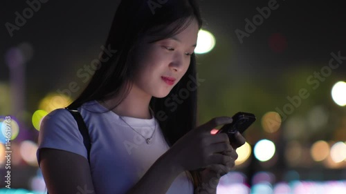 Woman using smartphone at night, Night lights, Bokeh of lights.