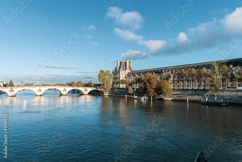 A picturesque and scenic view showcasing The Louvre Museum situated beautifully by the River Seine. Paris, France