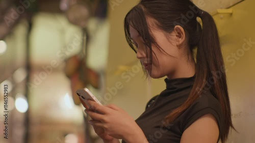 Woman using smartphone at night, Night lights, Bokeh of lights.