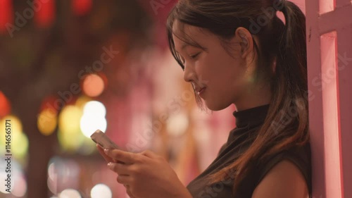 Woman using smartphone at night, Night lights, Bokeh of lights.