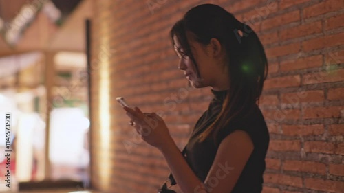 Woman using smartphone at night, Night lights, Bokeh of lights.