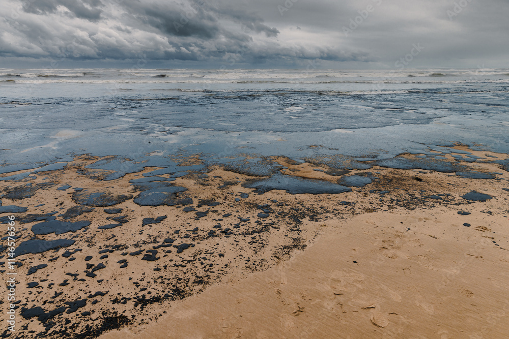 Oil leaked in coastline after a tanker wreck. Oil fuel polluted and destroy beach Oil leaked in coastline after a tanker wreck. Oil fuel polluted and destroy beach