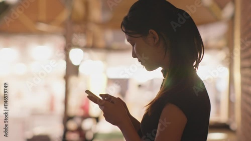 Woman using smartphone at night, Night lights, Bokeh of lights.