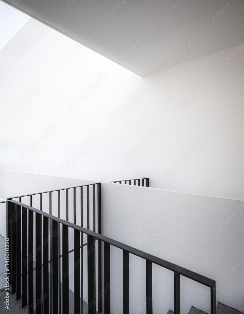 Architecture detail of building with white wall and black handrails Architecture detail of building with white wall and black handrails