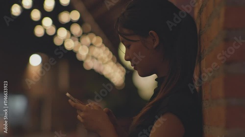 Woman using smartphone at night, Night lights, Bokeh of lights.