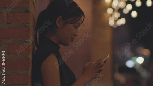 Woman using smartphone at night, Night lights, Bokeh of lights.