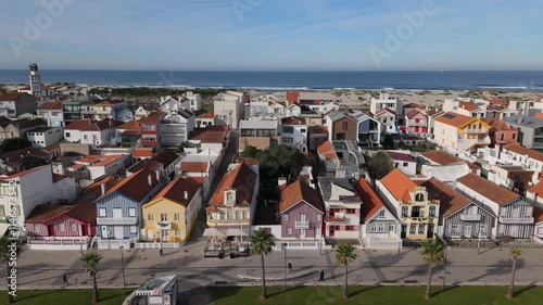 Aerial drone sideways panning of colourful houses along Costa Nova do Prado beach, Portugal