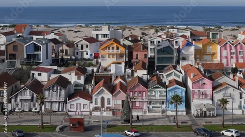 Aerial drone sideways panning of colourful houses along Costa Nova do Prado beach, Portugal