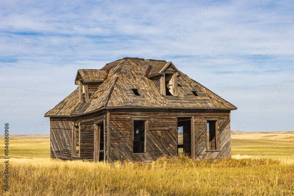 Abandoned, old house standing alone on Canadian prairie Abandoned, old house standing alone on Canadian prairie