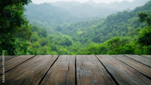 Empty wood table top with blur background of nature lush green forest. The table giving copy space for placing advertising product on the table along with beautiful green forest nature background.  photo