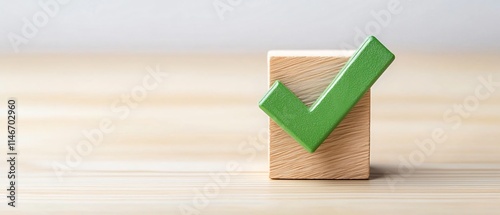 Checklist and decision making. Green checkmark on wooden block against a neutral background symbolizing affirmation and success.