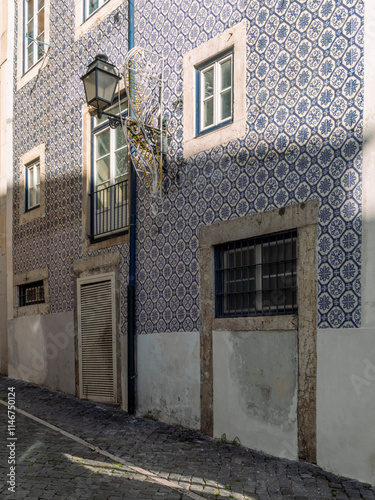 The narrow alleys and old buildings of the Alfama neighborhood in Lisbon in the late afternoon