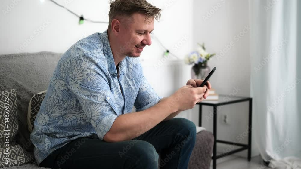 Young Attractive Man With Smartphone At Home Typing A Message In Social Media Young Attractive Man With Smartphone At Home Typing A Message In Social Media