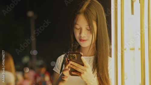 Woman using smartphone at night, Night lights, Bokeh of lights.