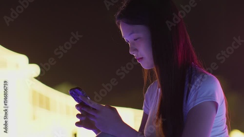 Woman using smartphone at night, Night lights, Bokeh of lights.