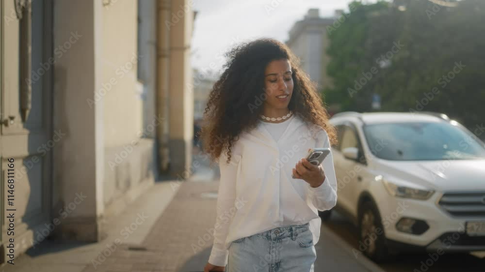 Beautiful biracial woman tourist taking selfie by smartphone on old city street. Happy Arabic lady traveling alone, rolling suitcase in downtown, picture for memory about summer trip in vacation Beautiful biracial woman tourist taking selfie by smartphone on old city street. Happy Arabic lady traveling alone, rolling suitcase in downtown, picture for memory about summer trip in vacation