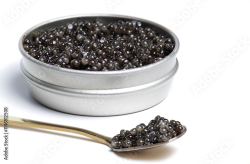 Black sturgeon caviar in gold spoon. Sturgeon caviar on a white background in a jar.