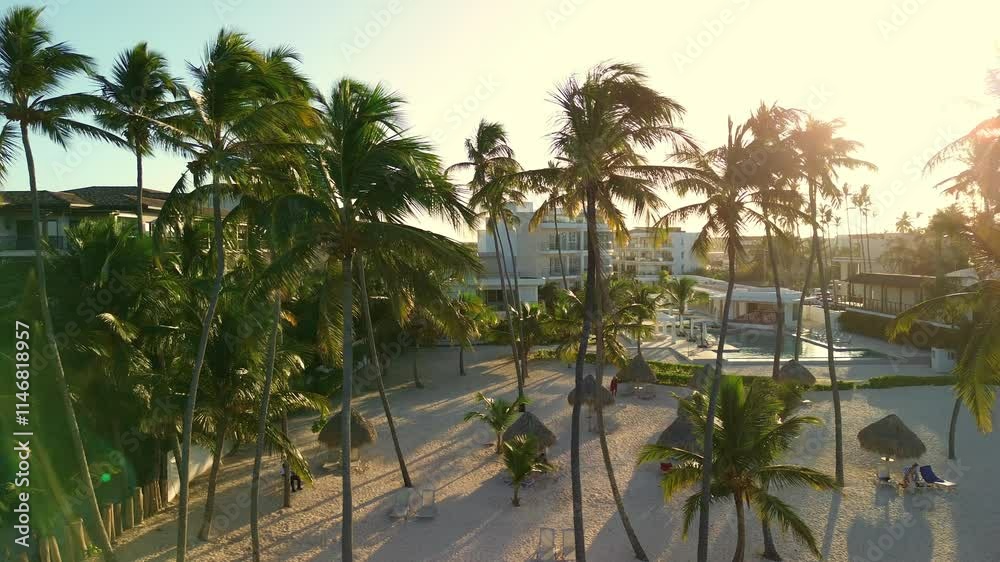 A stunning aerial view of a luxury hotel beach in Punta Cana. Golden sands, turquoise waters, and vibrant greenery frame the scene as guests enjoy the Caribbean coastline, relaxing and having fun A stunning aerial view of a luxury hotel beach in Punta Cana. Golden sands, turquoise waters, and vibrant greenery frame the scene as guests enjoy the Caribbean coastline, relaxing and having fun