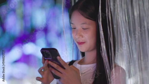 Woman using smartphone at night, Night lights, Bokeh of lights.