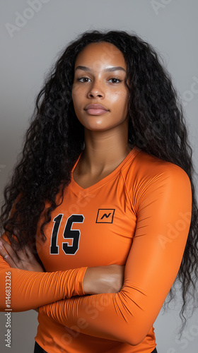 25 year old African American female volleyball player standing confident looking at camera posing for a magazine .