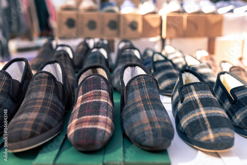 Checkered winter slippers for sale at a street stall