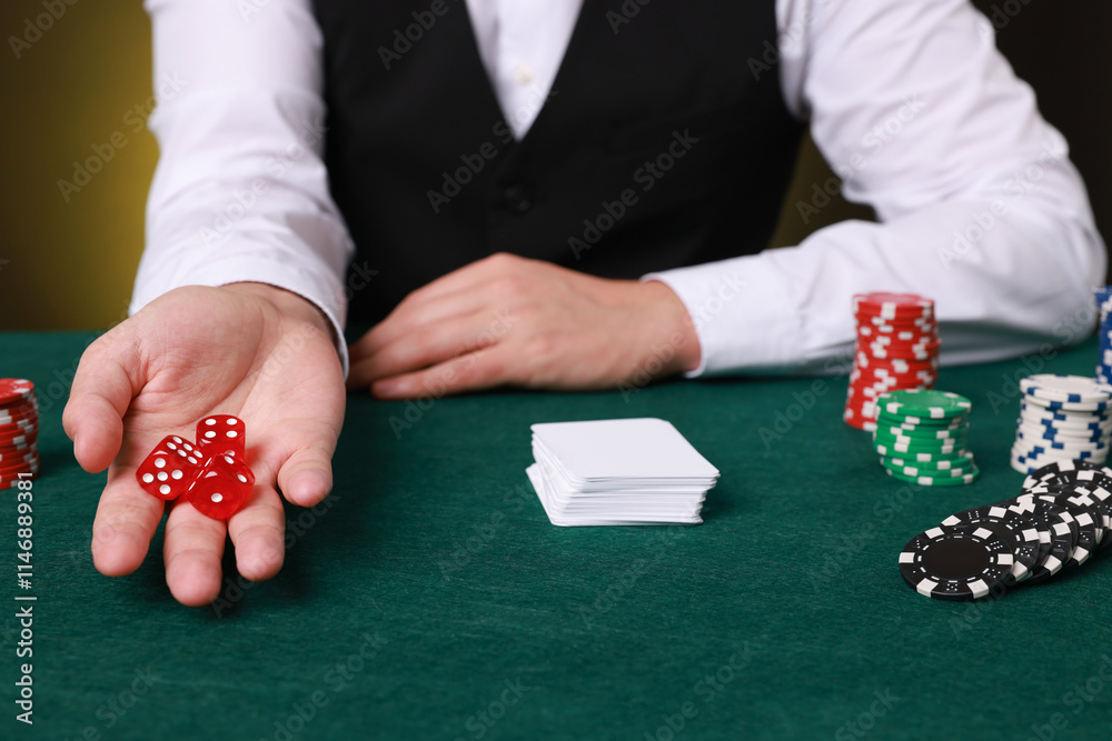 Professional croupier with dice at gambling table, closeup Professional croupier with dice at gambling table, closeup