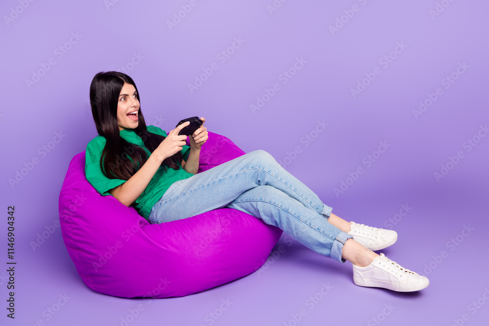 Young woman joyfully playing video games on a purple bean bag chair, with a vibrant green t-shirt and jeans, expressing excitement Young woman joyfully playing video games on a purple bean bag chair, with a vibrant green t-shirt and jeans, expressing excitement
