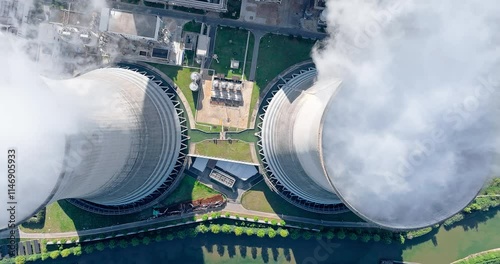 Aerial view of steam rises from the huge chimneys of the operating power plant