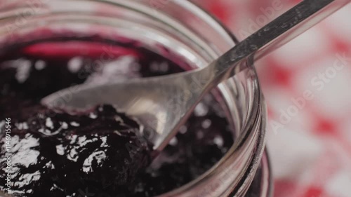 Cooking blueberry raspberry berrie jam with sugar, boiling marmalade, Jar of raspberry jam and fresh berries with leaves on a white wooden table.