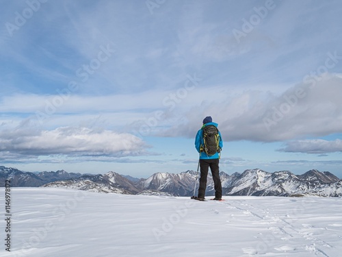 Hiker Admiring Snowy Peaks on Mont Chaberton photo