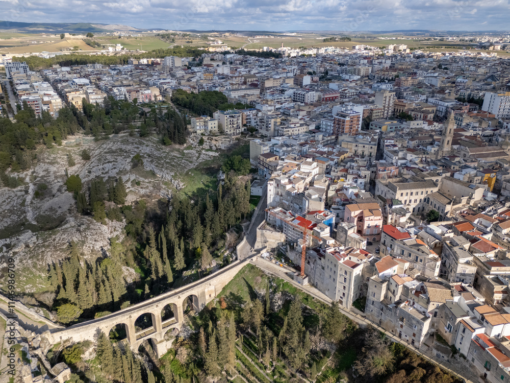 Fototapeta premium Aerial drone photo of the old Roman bridge in the town named Gravina in Puglia in southern Italy.