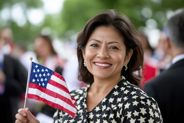 Happy smiling Female immigrant holding a small US flag the day of her naturalization ceremony	
