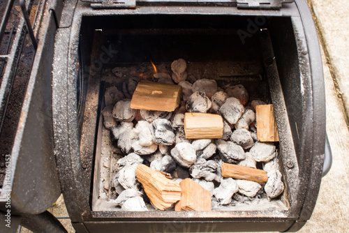 Charcoal with fire ready to cook food in a small grill