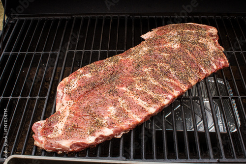 Pork spare ribs cooked and smoked on the barbeque photo