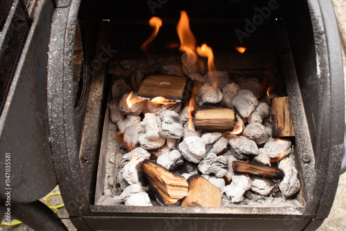 Charcoal with fire ready to cook food in a small grill