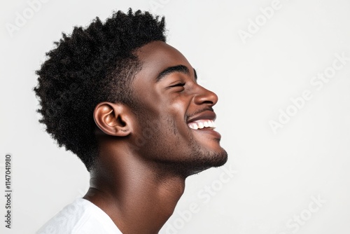 Close up profile portrait of handsome young black man laughing against isolated white background