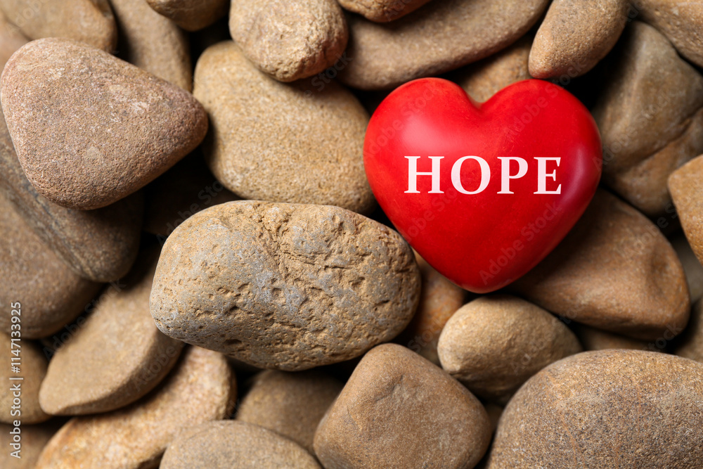 Red decorative heart with word Hope on stones, top view Red decorative heart with word Hope on stones, top view