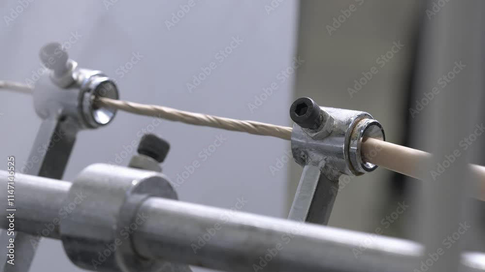 Forming cardboard tube on machine in large factory workshop. Special small cylinders provide creation of final shape of thin material Forming cardboard tube on machine in large factory workshop. Special small cylinders provide creation of final shape of thin material