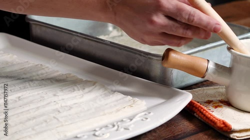 Making a Greek favorite, spinach pie with its richness of flavor with spinach, onions, feta cheese and all wrapped up in a flaky dough.  Spinach Pie ready for diner tonite. photo