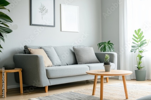 A modern  cozy living room featuring a gray sofa  plants  and a round coffee table.