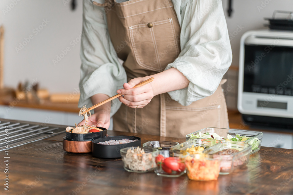 Fotografía キッチンでお弁当を作る女性の手元