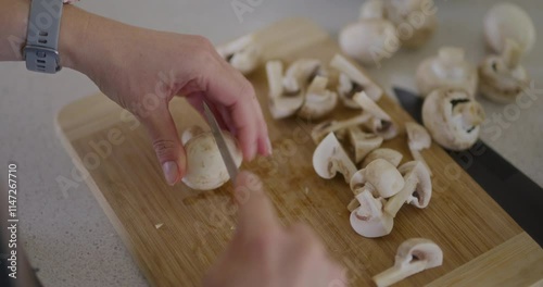 Shot from Above of Chef Slicing Mushrooms photo