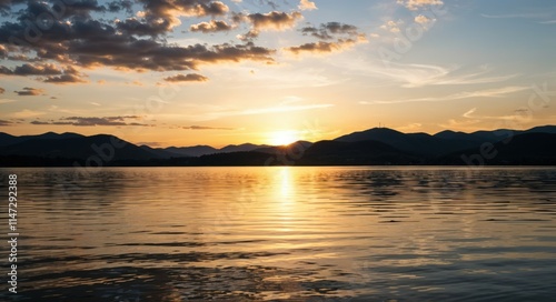 "Tranquil Lake at Sunset with Vibrant Reflections and Mountain Backdrop"